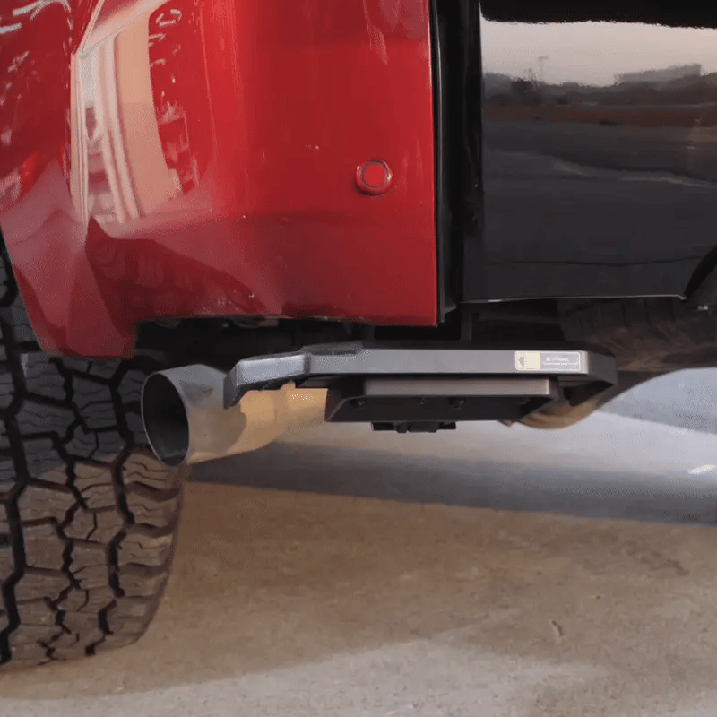 Operating the Wolfbox Retractable Truck Bed Step: Hands-free foot deployment and easy stow-away under the rear bumper.