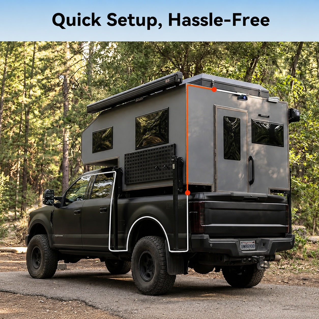 Hard-sided truck bed camper on a matte black pickup truck in a forest setting.