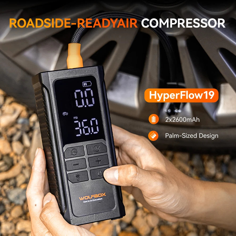 palm sized tire inflator held in two hands for quick roadside tire topping up | WOLFBOX HyperFlow19